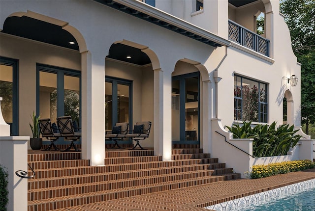 entrance to property featuring stucco siding