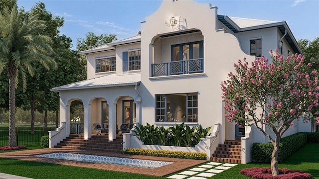 mediterranean / spanish-style home with covered porch, a balcony, and stucco siding