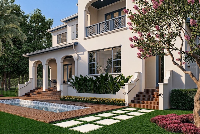 entrance to property with a balcony and stucco siding