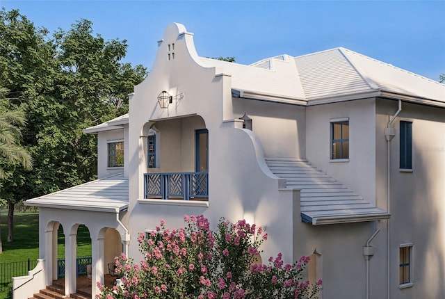 view of side of home with a yard and stucco siding