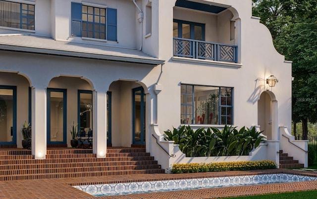 exterior space featuring a balcony and stucco siding