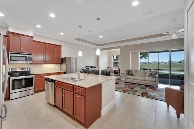 kitchen featuring hanging light fixtures, ceiling fan, sink, stainless steel appliances, and tasteful backsplash