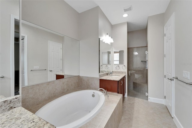 bathroom featuring tile flooring, plus walk in shower, and vanity