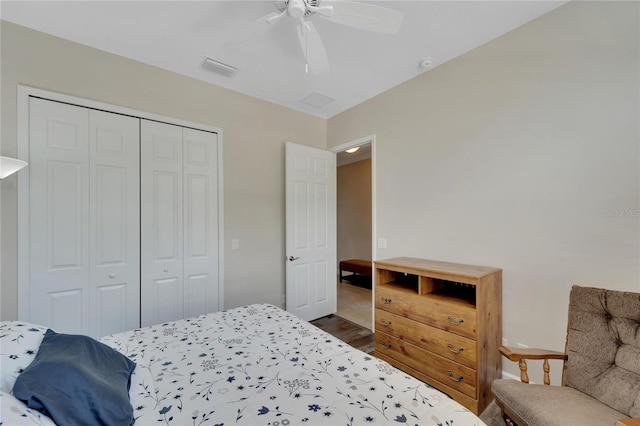 bedroom featuring a closet, ceiling fan, and dark wood-type flooring