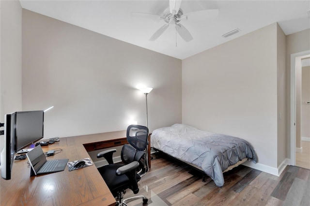 bedroom with hardwood / wood-style floors and ceiling fan