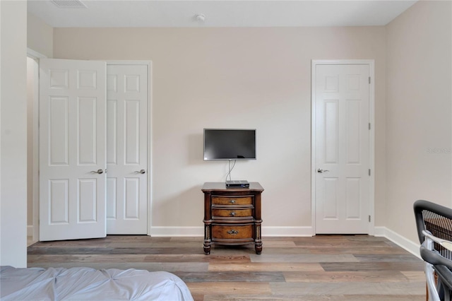 bedroom with a closet and light hardwood / wood-style flooring