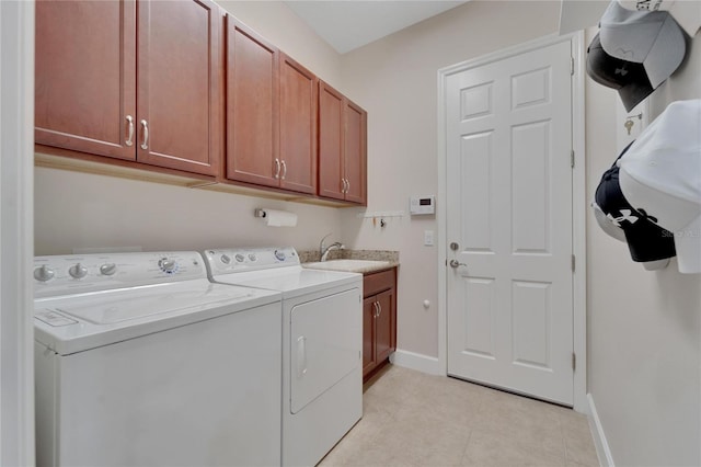 laundry room with cabinets, independent washer and dryer, sink, and light tile floors