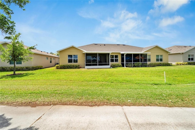 ranch-style home with a front lawn and a sunroom