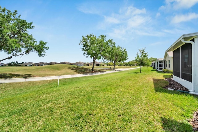 view of yard featuring a sunroom