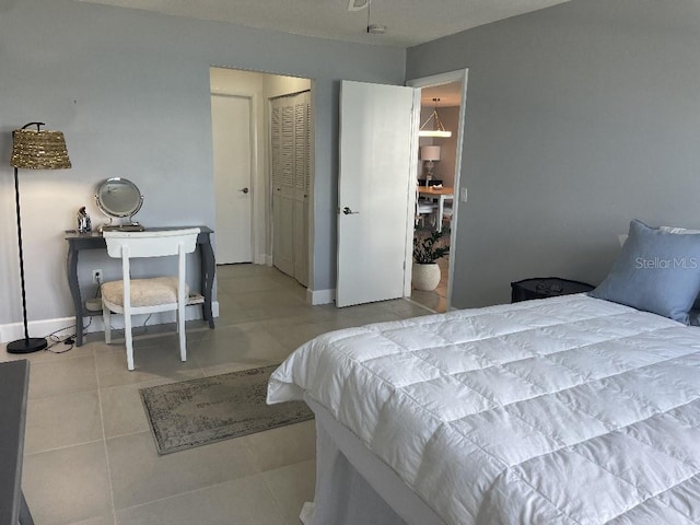 bedroom with a closet and light tile floors