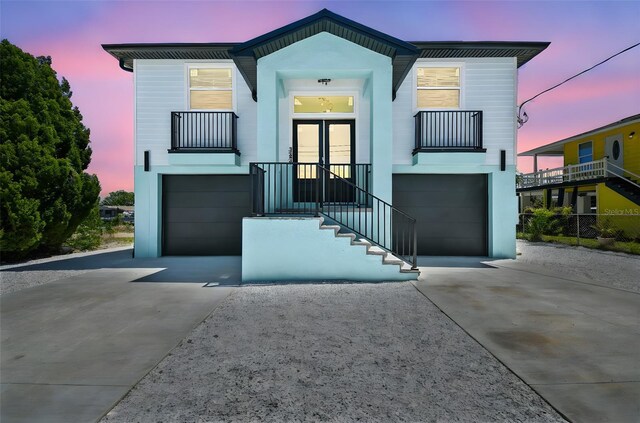 3230 Azalea Dr Lot 13, Hernando Beach, FL 34607 - view of front of property with a garage, a balcony, and concrete driveway