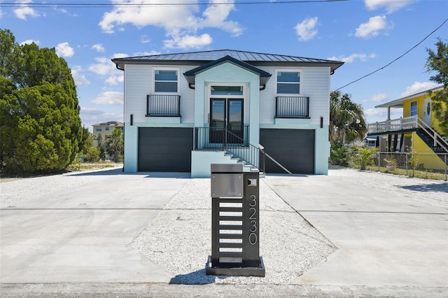 3230 Azalea Dr Lot 13, Hernando Beach, FL 34607 - view of front of home with an attached garage, a standing seam roof, and metal roof