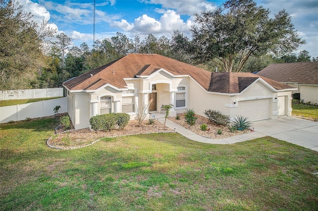 view of front of house featuring a garage and a front yard