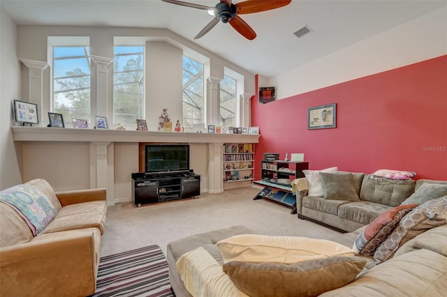 living room featuring ceiling fan, carpet floors, and vaulted ceiling