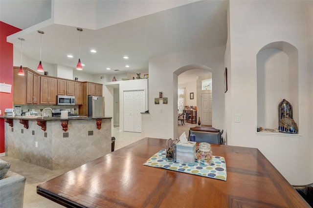 dining space with light tile patterned floors and sink