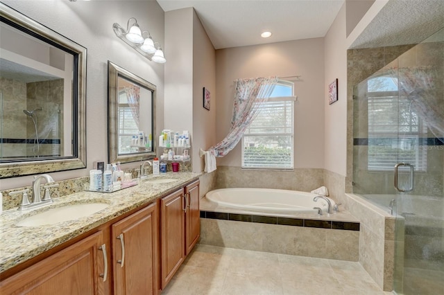 bathroom with tile patterned floors, vanity, and shower with separate bathtub