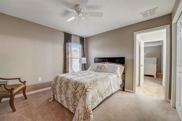 bedroom featuring light carpet, a closet, and ceiling fan