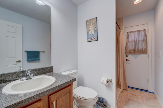 bathroom featuring a shower with curtain, tile patterned flooring, vanity, and toilet