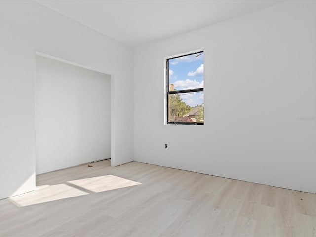 spare room with light wood-type flooring