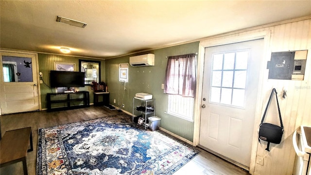 doorway to outside featuring a wall mounted air conditioner and dark hardwood / wood-style flooring