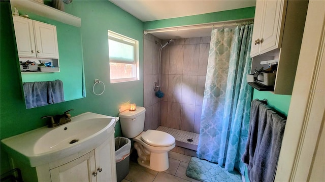 bathroom with tile floors, toilet, curtained shower, and vanity