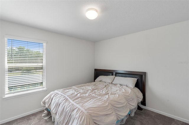 bedroom with carpet floors and baseboards