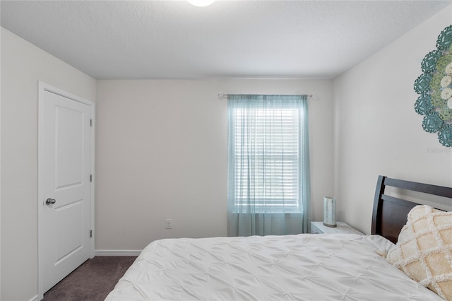 bedroom with a textured ceiling and carpet floors