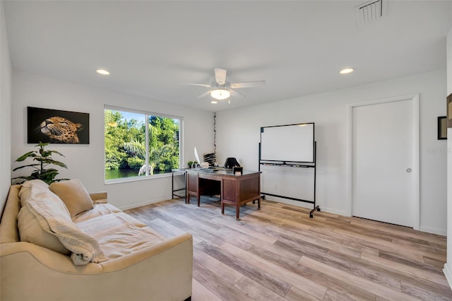 office space with light hardwood / wood-style floors and ceiling fan