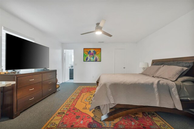 carpeted bedroom with ceiling fan and ensuite bathroom