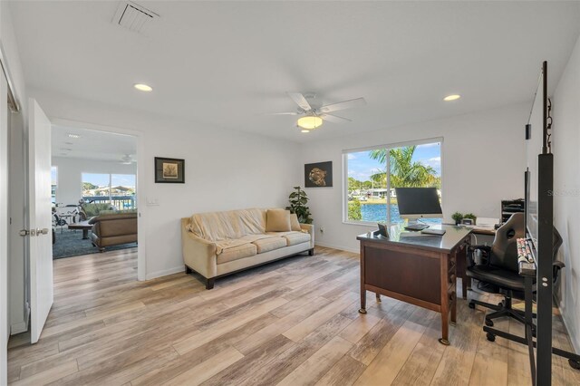 home office featuring light wood-type flooring and ceiling fan