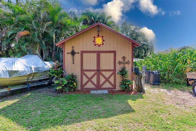 view of outbuilding featuring a lawn