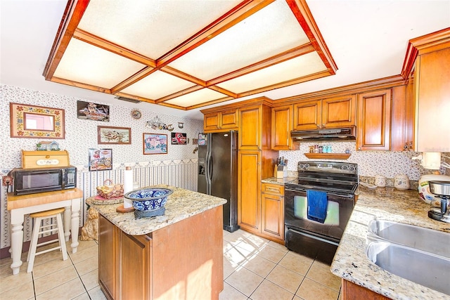 kitchen featuring light tile patterned floors, black appliances, sink, and light stone countertops