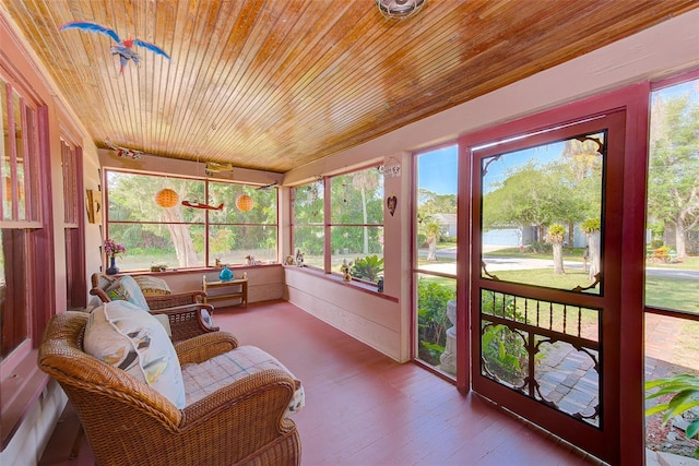 sunroom / solarium with wood ceiling and a healthy amount of sunlight