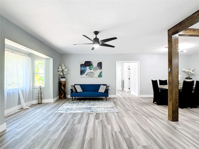 sitting room with ceiling fan and light wood-type flooring