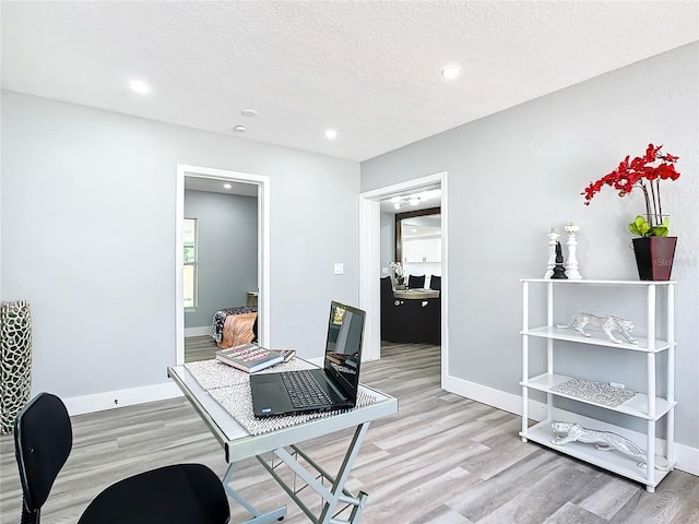 office featuring a textured ceiling and light wood-type flooring