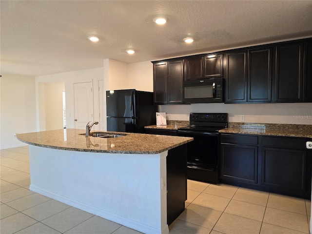 kitchen featuring sink, an island with sink, and black appliances