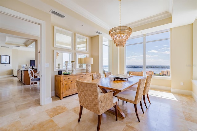 dining room with crown molding, a water view, and an inviting chandelier