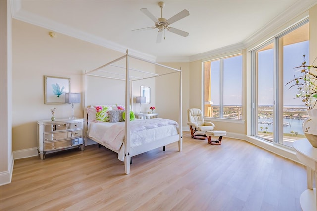 bedroom featuring ceiling fan, crown molding, and light hardwood / wood-style flooring