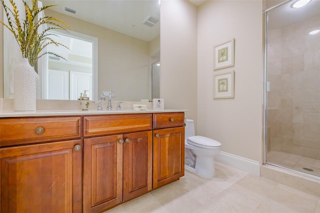 bathroom featuring vanity, a shower with shower door, and toilet