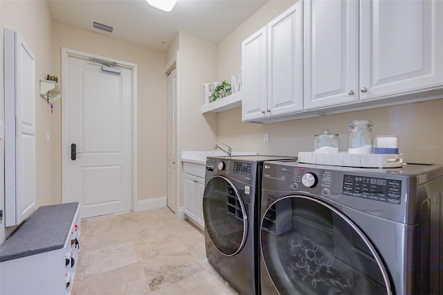 laundry room featuring sink, cabinets, and separate washer and dryer