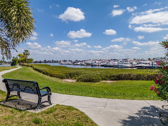 surrounding community featuring a water view and a yard