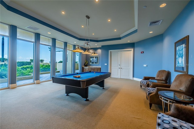 recreation room with pool table, light colored carpet, and a tray ceiling