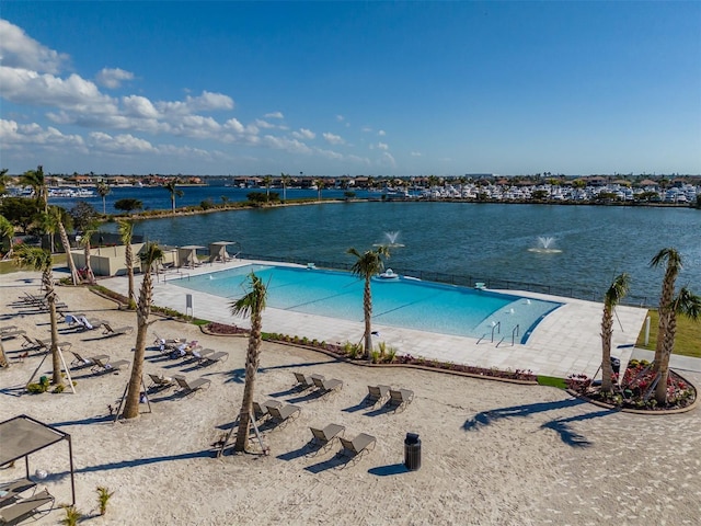 community pool with a water view and a patio