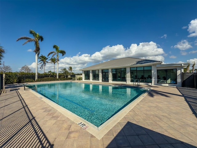 pool featuring a patio area and fence