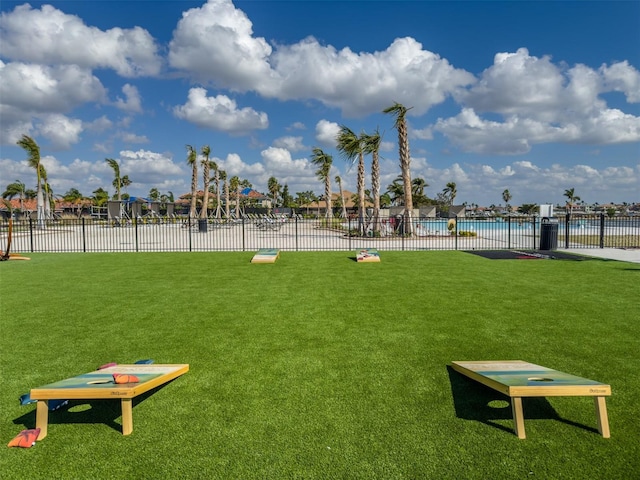 surrounding community featuring a yard, fence, and a pool