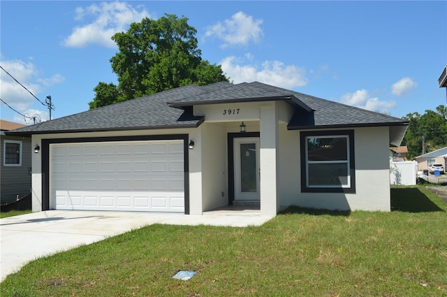 view of front of property featuring a front lawn and a garage