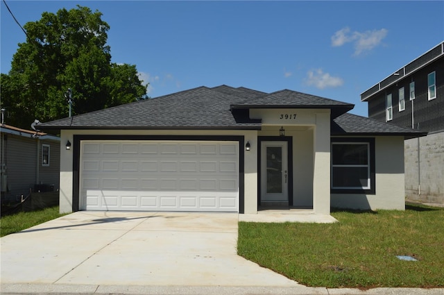 view of front facade featuring a front yard and a garage