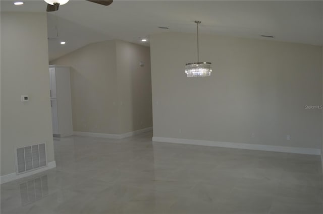 tiled empty room with ceiling fan with notable chandelier and vaulted ceiling