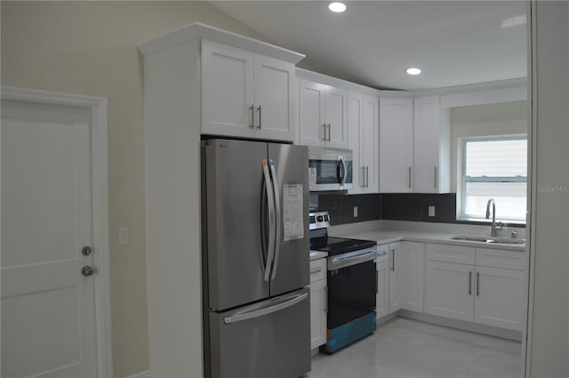 kitchen featuring sink, light tile floors, white cabinets, backsplash, and stainless steel appliances