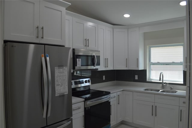 kitchen featuring white cabinetry, tasteful backsplash, appliances with stainless steel finishes, and sink